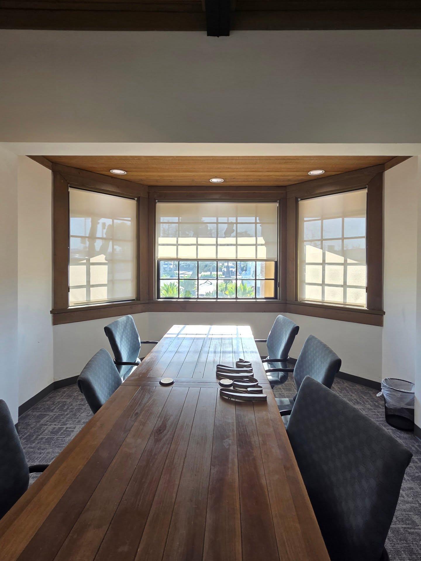 Bright dining nook with white plantation shutters installed by Elite Blinds
